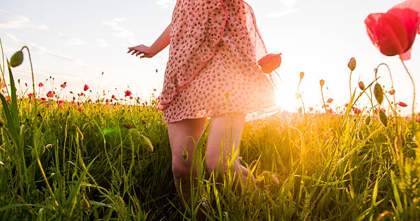 istock Woman's Legs In The Poppy Meadow 493560348