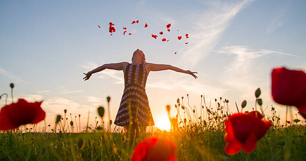 istock Woman Throwing Petals In The Meadow 493560376