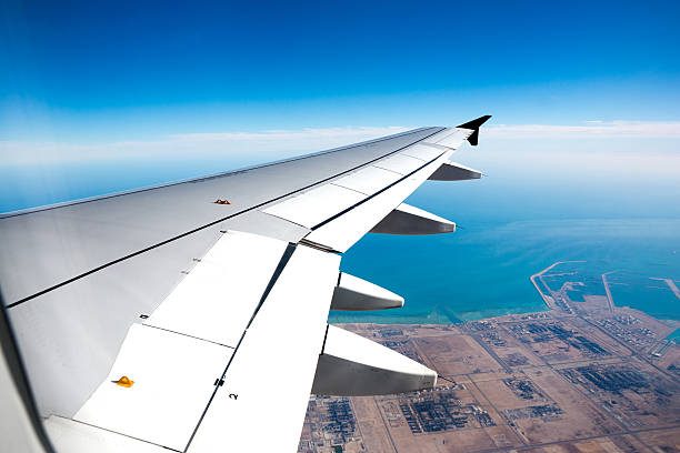 istock Wing of airplane during landing 493561028