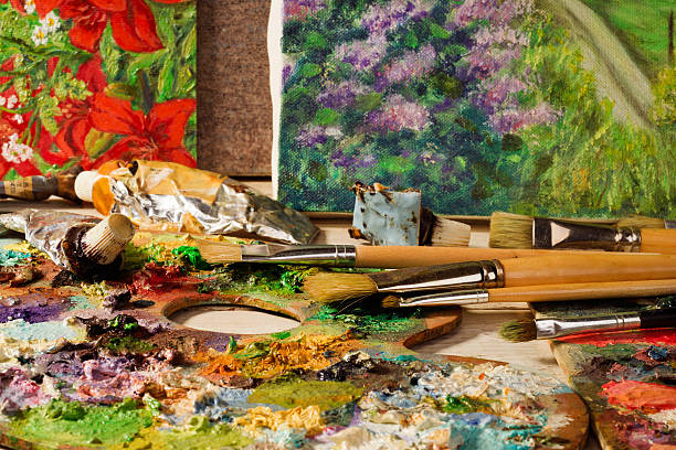 istock palette with paintbrushes and canvas  paintings 493561094