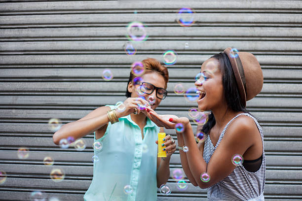 istock Two African girls blowing bubbles 493565785