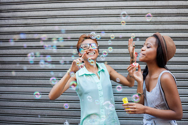 istock Two African girls blowing bubbles 493565787
