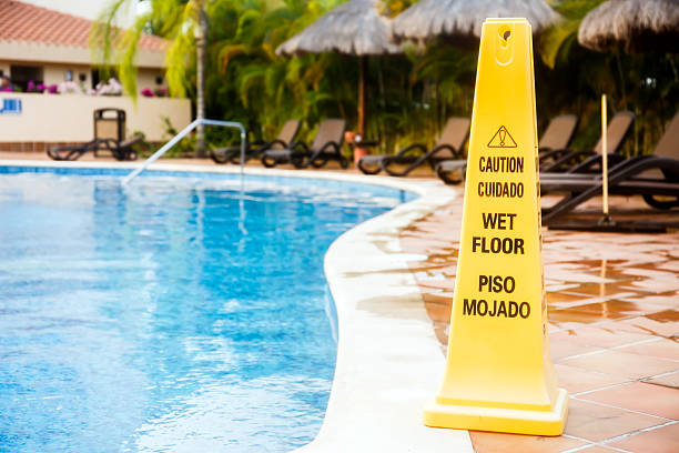 Wet floor warning Wet floor warning sign on a swimming pool in Mexico swimming pool accident stock pictures, royalty-free photos & images