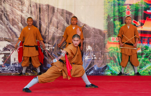 Hong Kong, China - May 3, 2014: Group of monks from Shaolin temple performs wushu at Po Lin monastery on May 3, 2014 in Hong Kong, China. Group of Shaolin monks do no-charge show to promote chinese martial arts.