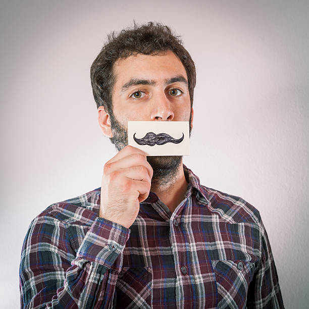istock hipster man with fake paper moustaches 493569089