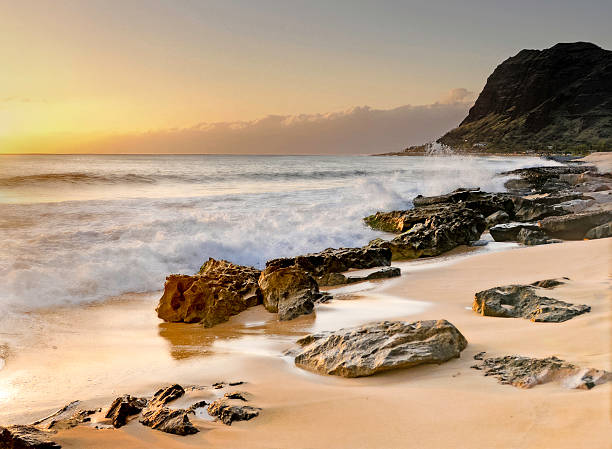 istock Waves crashing on the rocks at sunrise or sunset 493570539