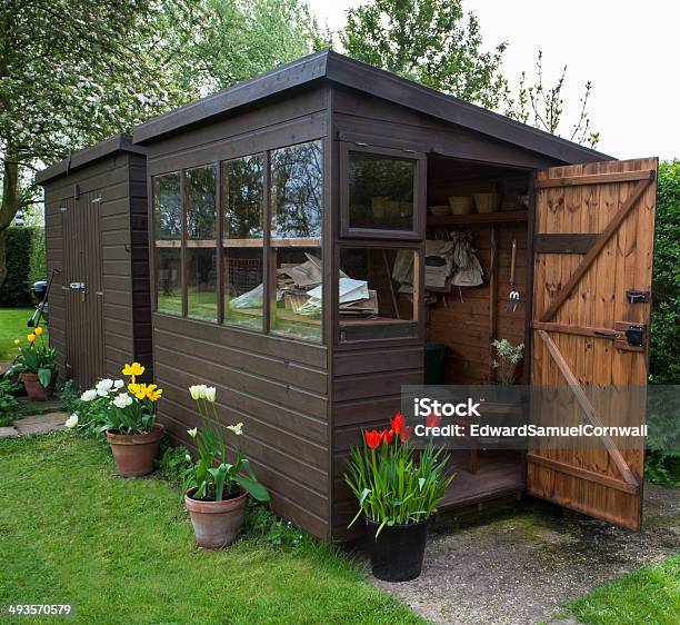 Garden Shed Exterior With Open Door Tools And Plants Stock Photo - Download Image Now