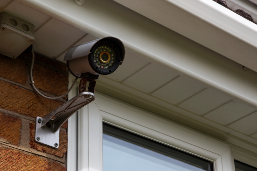 CCTV mounted on house exterior wall.