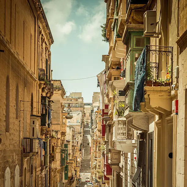 typical narrow street with stairs in the city Valetta on the island of Malta