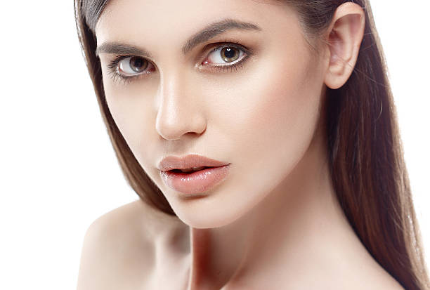 istock Beautiful woman face close up studio white sexy lips 493573386
