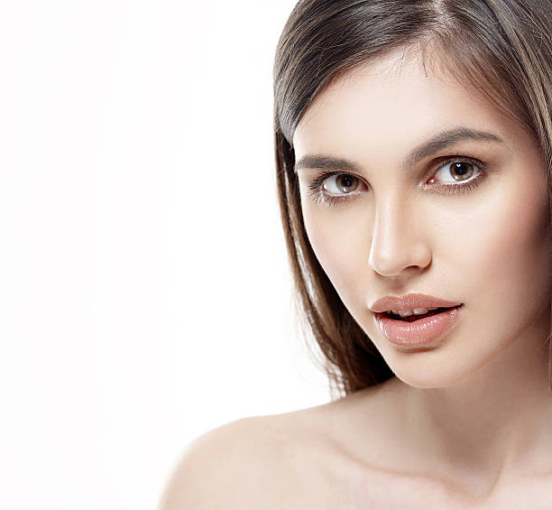 istock Beautiful woman face close up studio white sexy lips 493573484