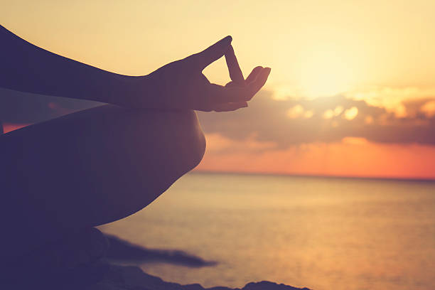 istock Young woman practicing yoga on the beach. 493575584