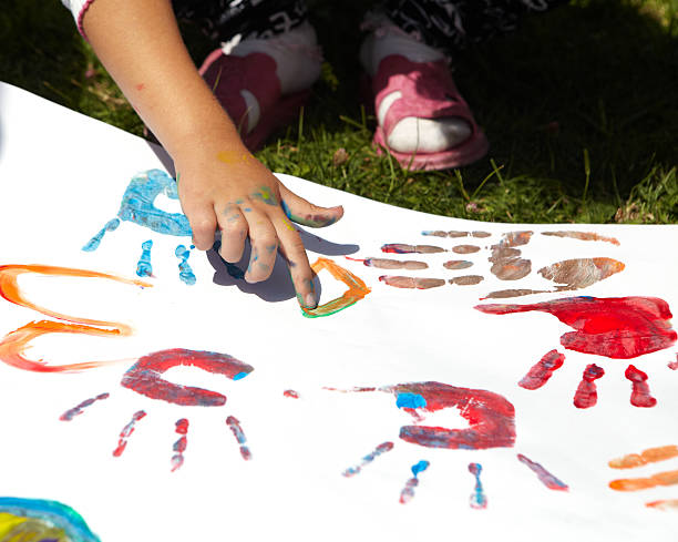 istock Little girl draws paints 493576690