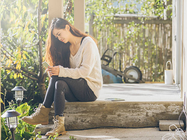 istock asian woman checking phone messages 493577498