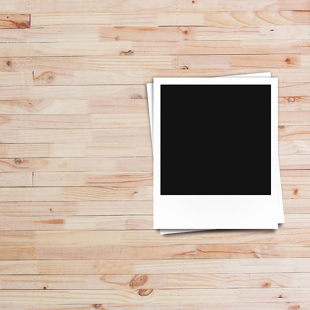 istock polaroid photo frame on wood plank background 493577744