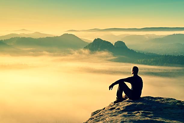 istock Hiker in black on rocky peak. Wonderful daybreak in mountains 493579396