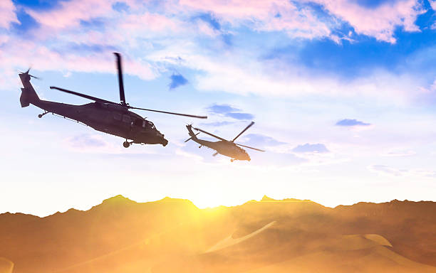 istock Army helicopters flying over desert 493580840