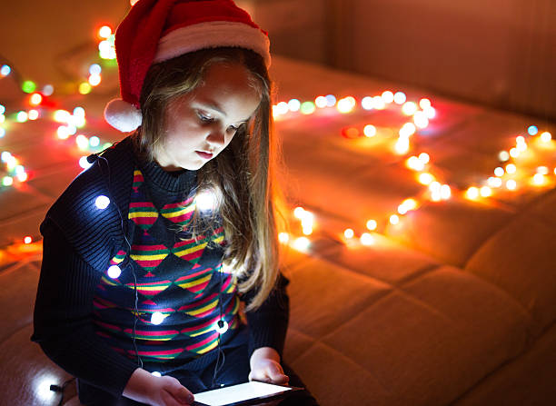 istock Child in christmas hat with tablet 493581612