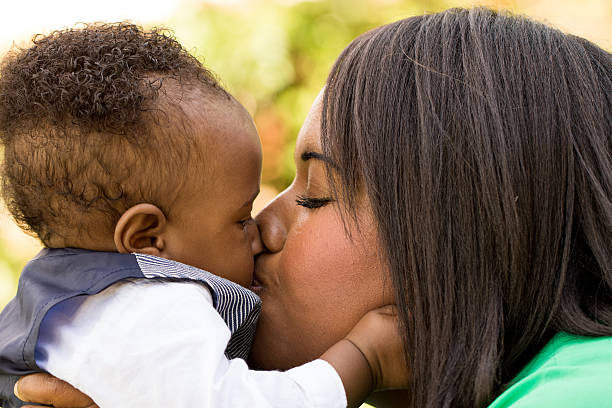 istock African American mother holding her son. 493584896