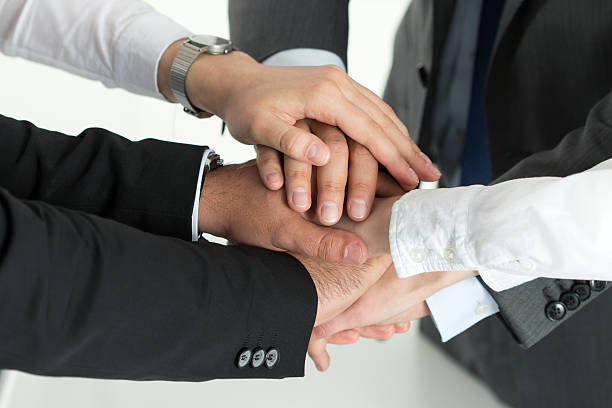 istock Closeup of business team showing unity with putting their hands 493594140