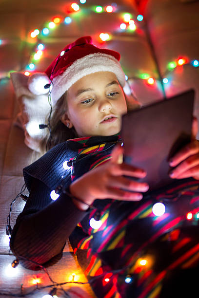 istock Child in christmas hat with tablet 493595414