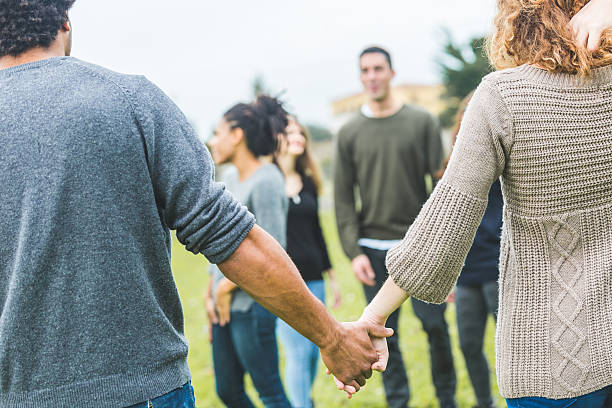 istock Multiethnic group of friends holding hands in a circle 493595842