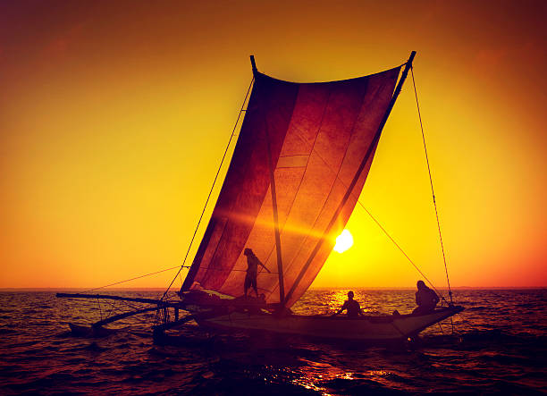 Fishermen on a catamaran at Sunset Concept