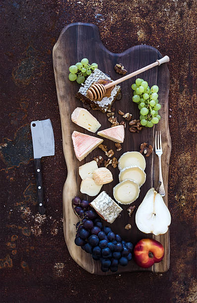 istock Wine appetizers set: French cheese selection, honeycomb, grapes, peach and 493598114
