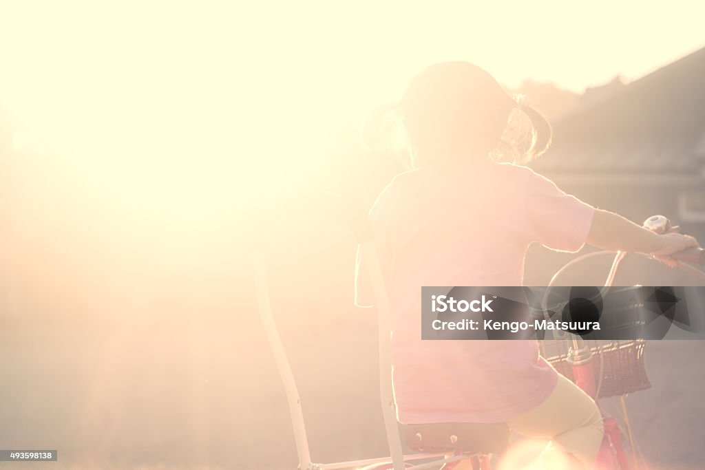 Bicycle kid of the sunset Season : summer, fall 2015 Stock Photo