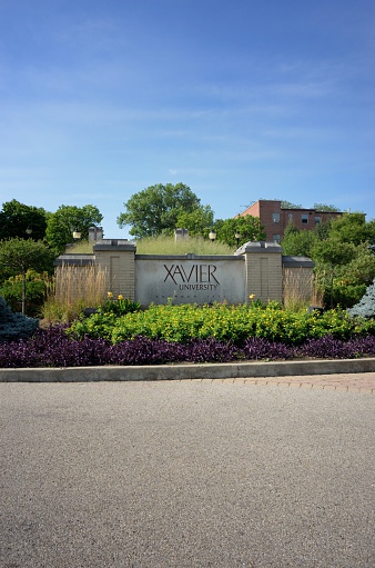 Cincinnati, Ohio, USA - August 8, 2015: Photograph of sign at the entrance to Xavier University Founded 1831.  Image taken at the roundabout on Ledgewood Road in Cincinnati.