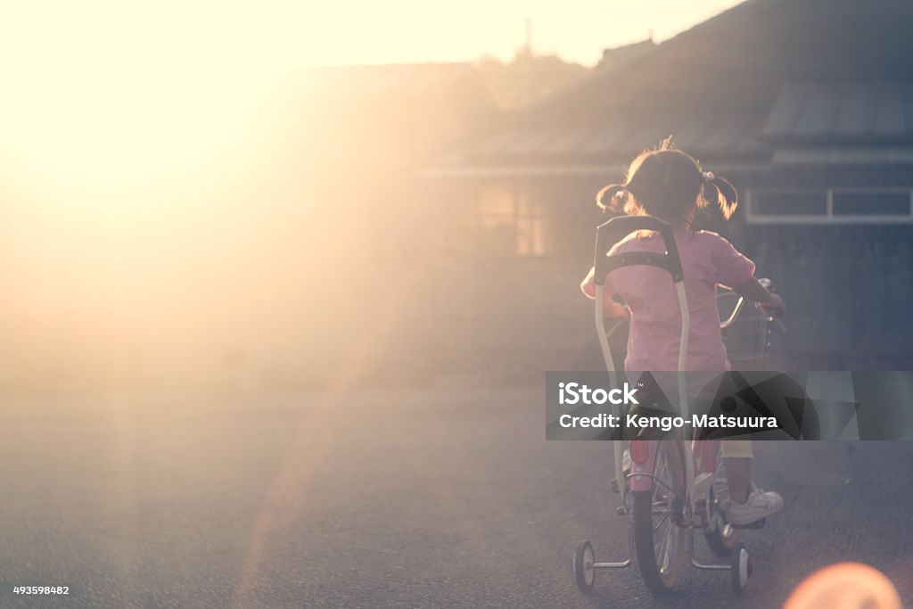 Bicycle kid of the sunset Season : summer, fall Childhood Stock Photo