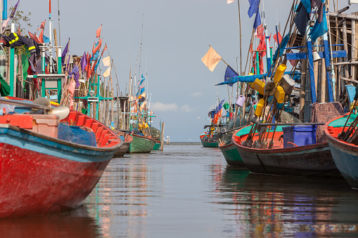 Colorful fishing boats floating along a canal after come back from the sea, Phetchaburi, Thailand.