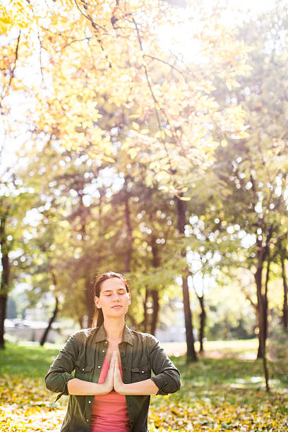 istock Woman resting while practicing yoga in the park 493598784