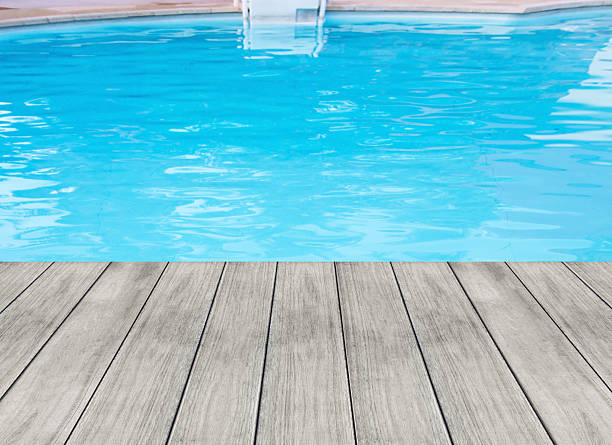 istock Blue swimming pool and wooden deck ideal for background 493599024