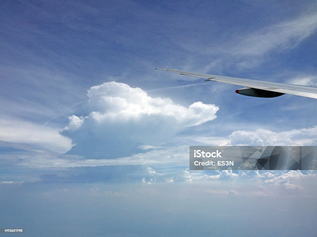 Flying high View from the airplane window, cloud and airplane wing  2015 Stock Photo