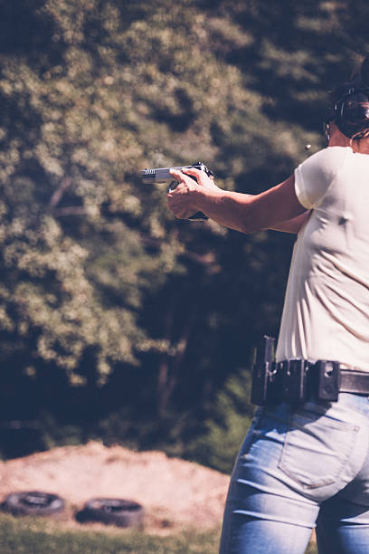 istock Woman pointing a gun 493604148