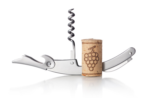 Wine bottle, hand with a corkscrew and a broken cork on a gray background. A man's hand holds a corkscrew with a broken wine stopper.