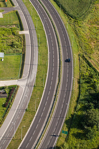 istock aerial view of highway with green fields 493605252
