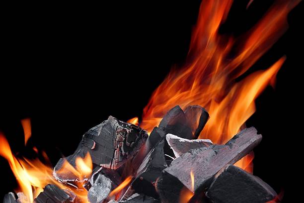 istock Hot Glowing Charcoal With Bright Flames In The Dark Close-up 493605786