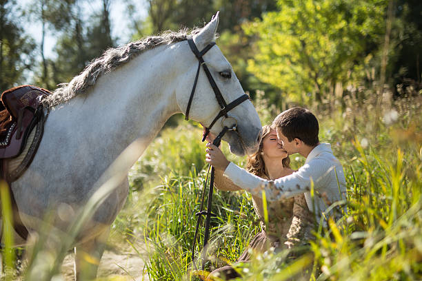 istock Young couple with horse 493606100