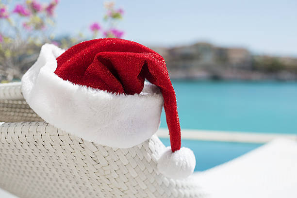 Red Christmas hat by the pool Red Christmas hat by the pool  swimming cap stock pictures, royalty-free photos & images