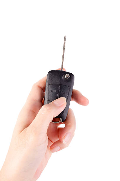 istock Hand holding car keys isolated on white background 493608205