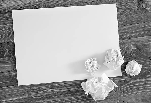 istock paper on wooden background 493611981