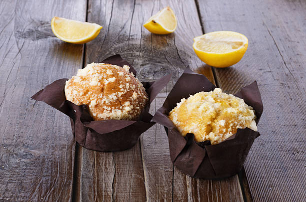 Lemon flavoured muffins on dark wooden background stock photo