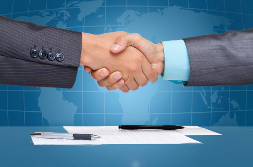 businessmen handshake after sign up contract close up hands, over blue digital world globe map background, Concept of global international business collaboration, communication