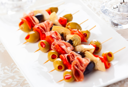 Antipasti skewers with olives,red pepper,artichoke hearts and salami for holiday