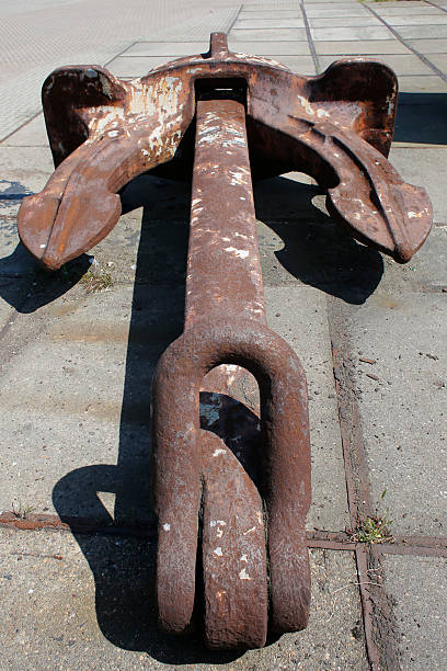 Anchor Full Cast Iron Full view of rusty anchor made of cast iron laying down in depot. arma-globalphotos stock pictures, royalty-free photos & images