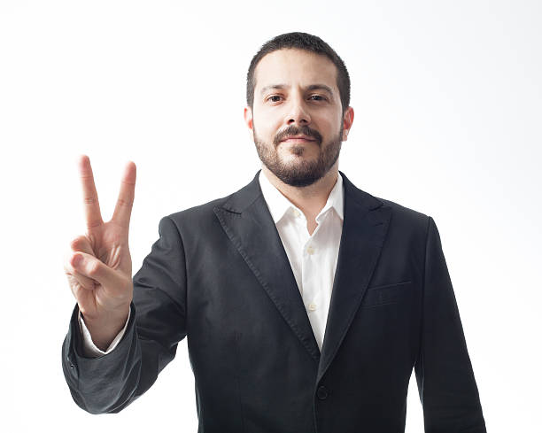 istock Young businessman showing peace sign. 493614181