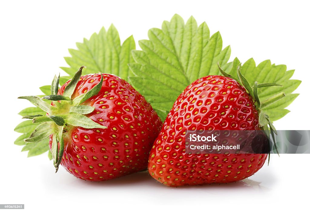 Ripe strawberries with leaves isolated on a white Ripe strawberries with leaves isolated on a white background Berry Fruit Stock Photo