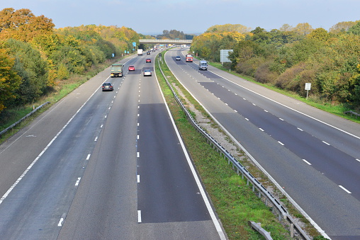 The M23 motorway near the junction with Gatwick Airport at around 13.00 on a October Fall day. The traffic at this time of day is light.